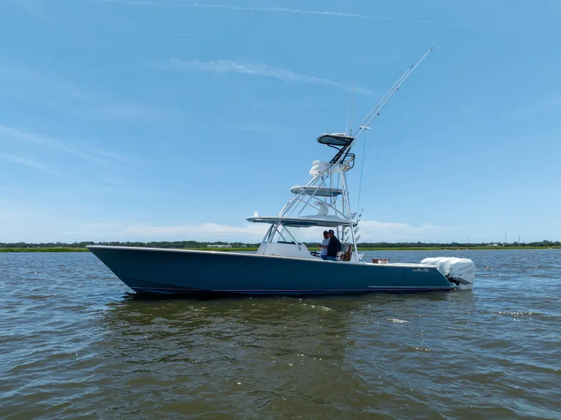 Slide: The Image of 2022 Valhalla Boatworks V41 on calm water under clear blue sky. - 5