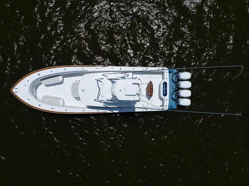 Slide: The Image of Overhead view of 2022 Valhalla Boatworks V41 on water, showcasing sleek design and triple engines. - 8