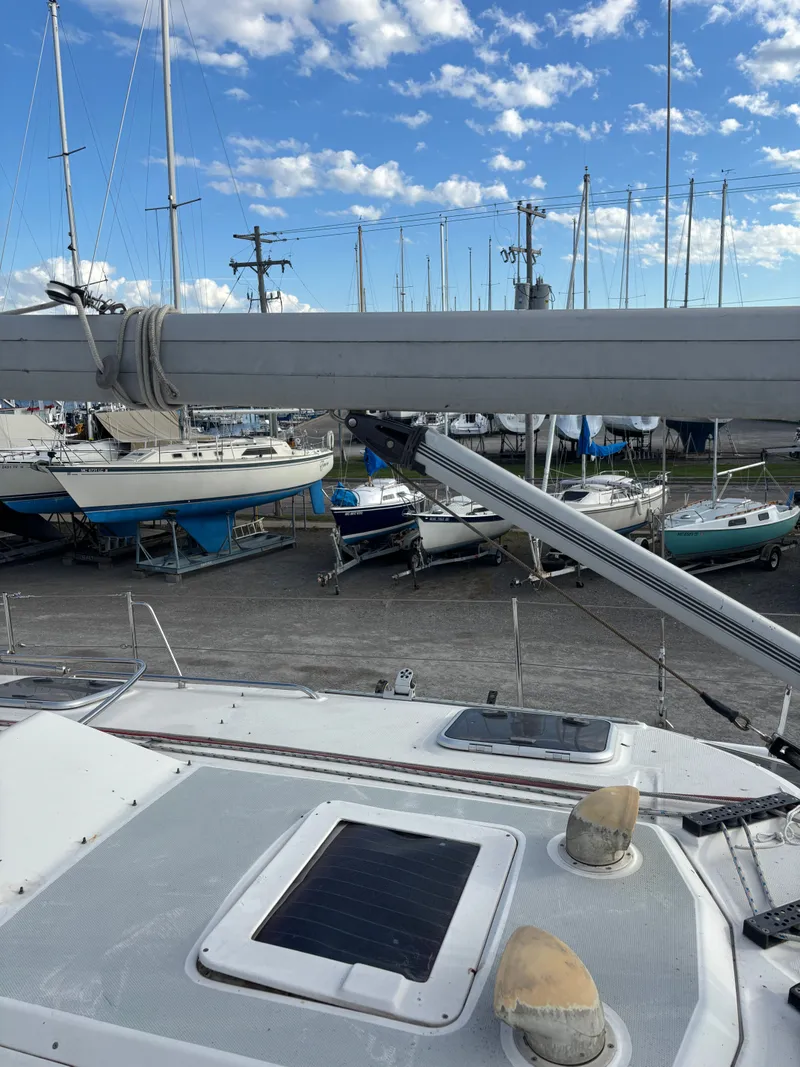 Slide: The Image of Hunter 460 sailboat from 2001 in a marina with other boats under a blue sky. - 15