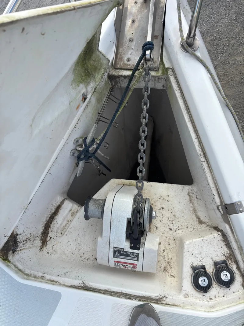 Slide: The Image of Anchor chain and windlass on a 2001 Hunter 460 sailboat deck. - 19