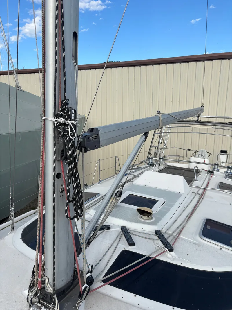 Slide: The Image of Sailboat deck of 2001 Hunter 460 with mast and rigging, docked outdoors. - 23