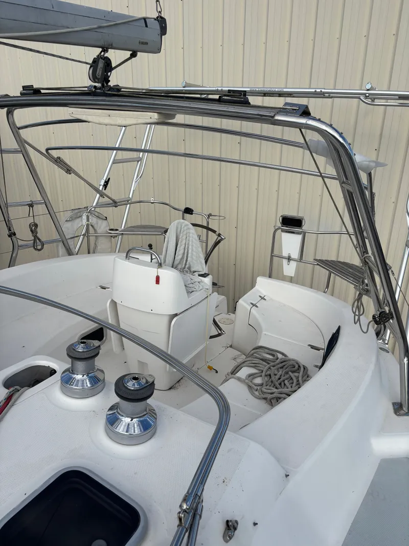 Slide: The Image of 2001 Hunter 460 sailboat cockpit with winches, ropes, and steering wheel. - 29