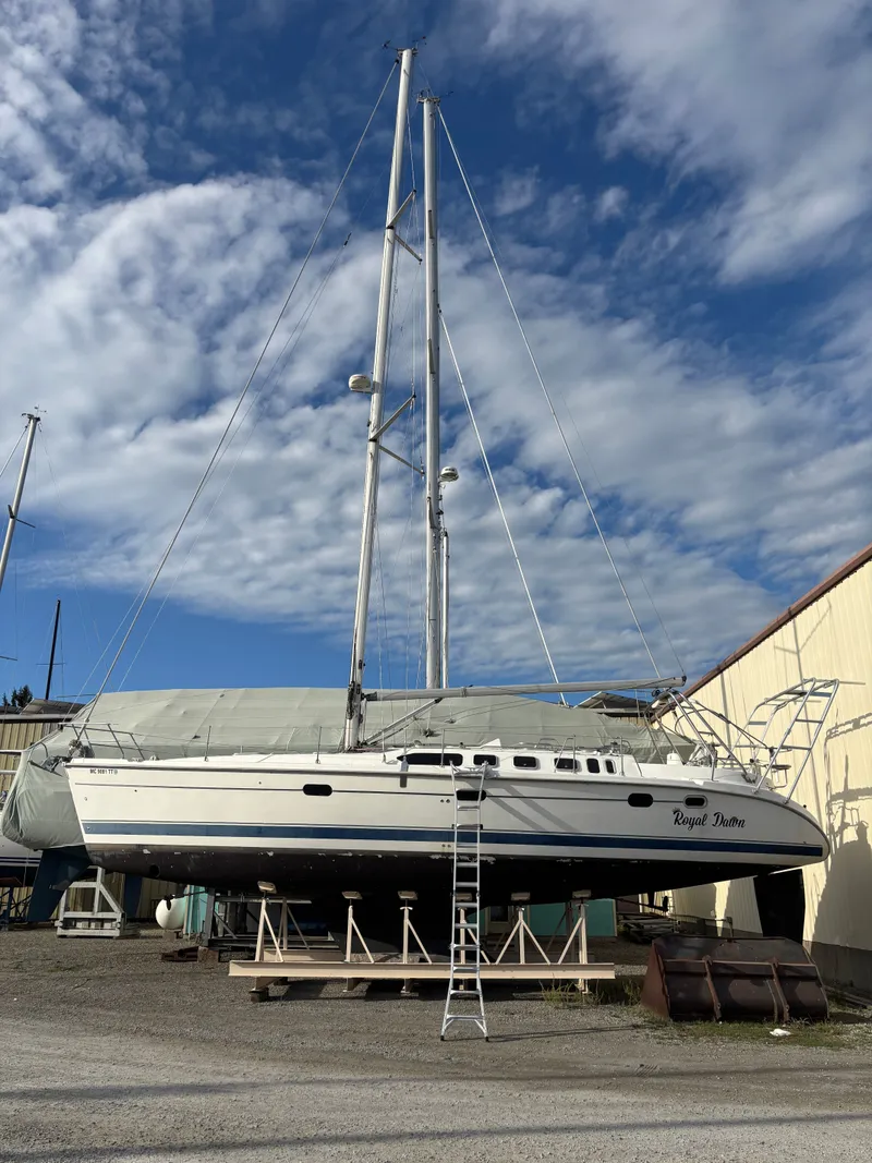 Slide: The Image of Sailboat Hunter 460, 2001 model, on dry dock under a partly cloudy sky. - 3