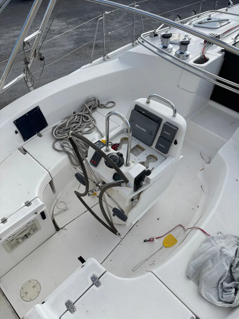 Slide: The Image of Cockpit of 2001 Hunter 460 sailboat with steering wheel and navigation equipment. - 31