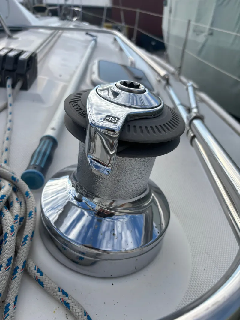 Slide: The Image of Chrome winch on 2001 Hunter 460 sailboat deck with ropes and railing. - 42