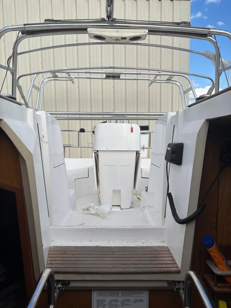 Slide: The Image of Interior view of a 2001 Hunter 460 sailboat cockpit with steering wheel and equipment. - 47