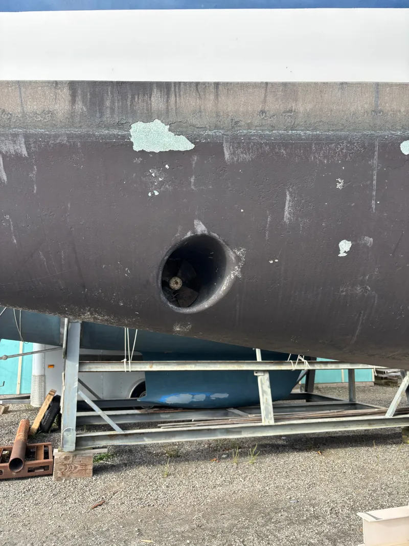 Slide: The Image of 2001 Hunter 460 sailboat hull with visible bow thruster in dry dock. - 7
