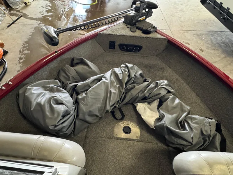 Slide: The Image of 2014 Tracker Pro Guide V-175 Combo boat interior with gray cover and trolling motor. - 12