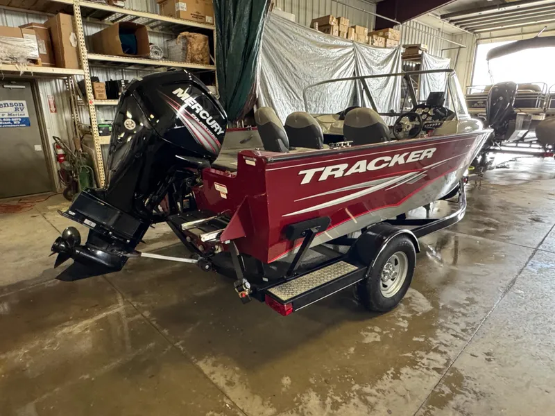 Slide: The Image of 2014 Tracker Pro Guide V-175 Combo boat with Mercury outboard motor in a garage. - 3