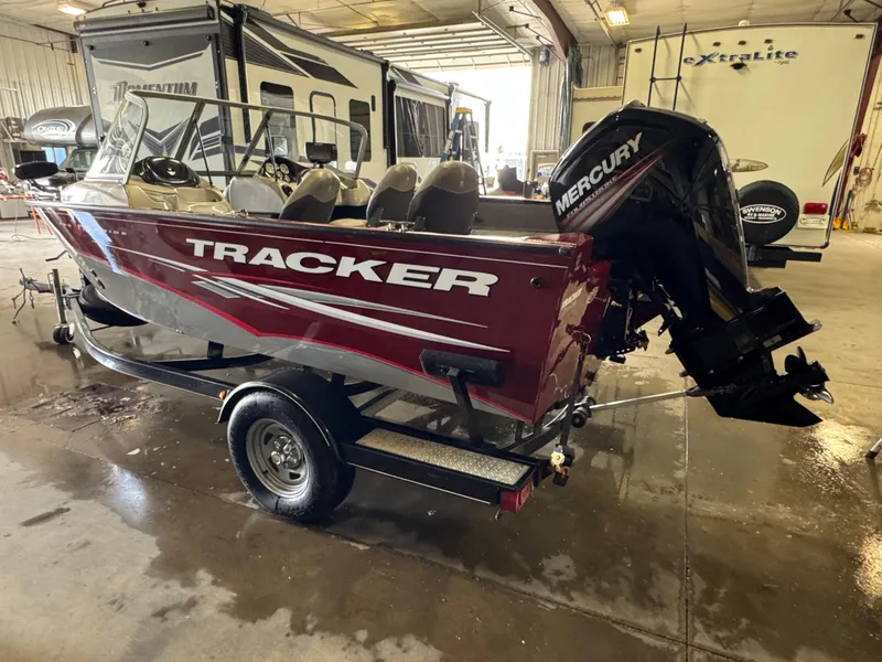 Slide: The Image of 2014 Tracker Pro Guide V-175 Combo boat with Mercury engine in a garage. - 4