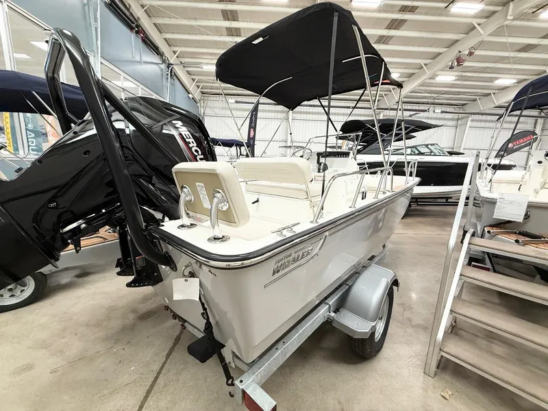 Slide: The Image of 2025 Boston Whaler 170 Montauk boat displayed indoors on a trailer. - 2