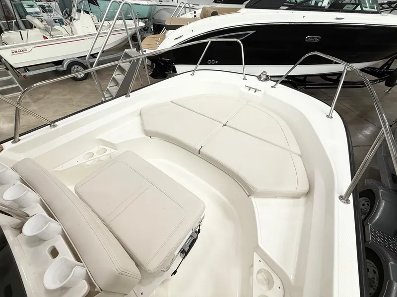 Slide: The Image of 2025 Boston Whaler 170 Montauk boat interior with cushioned seating and stainless steel railings. - 8