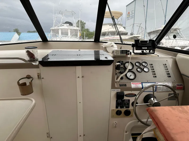 Slide: The Image of 2001 Bayliner Ciera Classic Cabin Cruiser 2859 cockpit with steering wheel and control panel. - 4