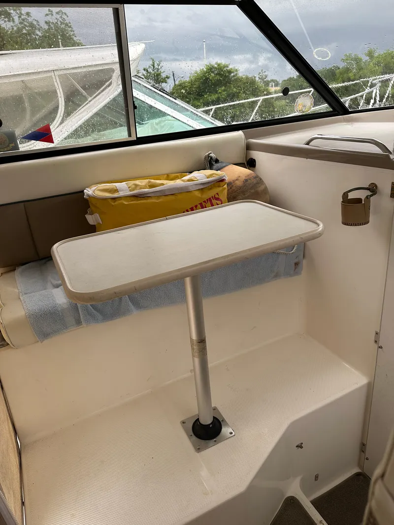 Slide: The Image of 2001 Bayliner Ciera Classic Cabin Cruiser 2859 interior with table and seating area. - 5