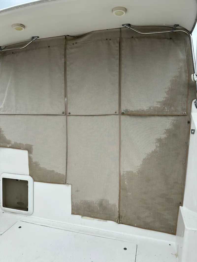 Slide: The Image of 2001 Bayliner Ciera Classic Cabin Cruiser 2859 interior with beige curtains. - 6