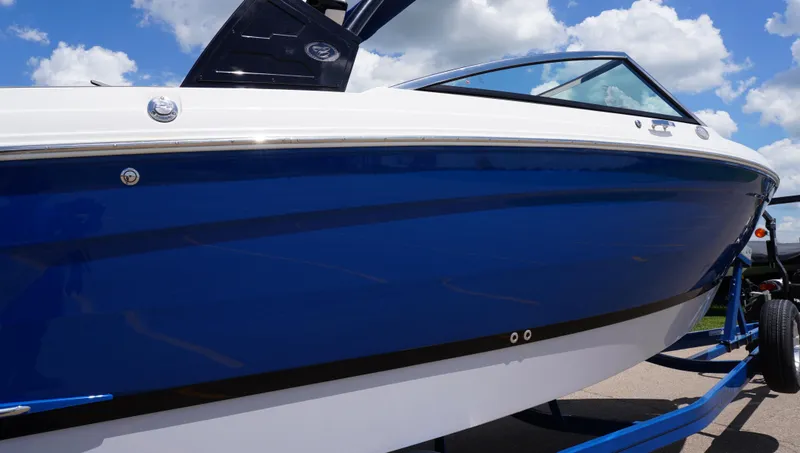 Slide: The Image of 2022 Cobalt R6 boat with sleek blue and white design under a cloudy sky. - 11