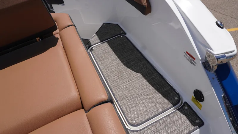 Slide: The Image of 2022 Cobalt R6 boat interior with brown seating and textured flooring. - 15