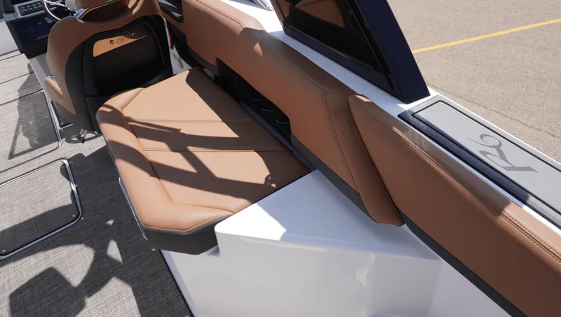 Slide: The Image of 2022 Cobalt R6 boat interior with brown leather seating and modern design. - 16