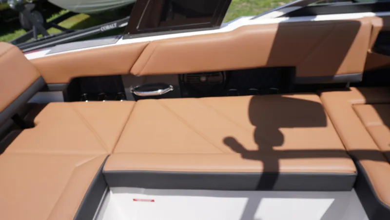 Slide: The Image of 2022 Cobalt R6 boat interior with tan leather seating and sleek design. - 18