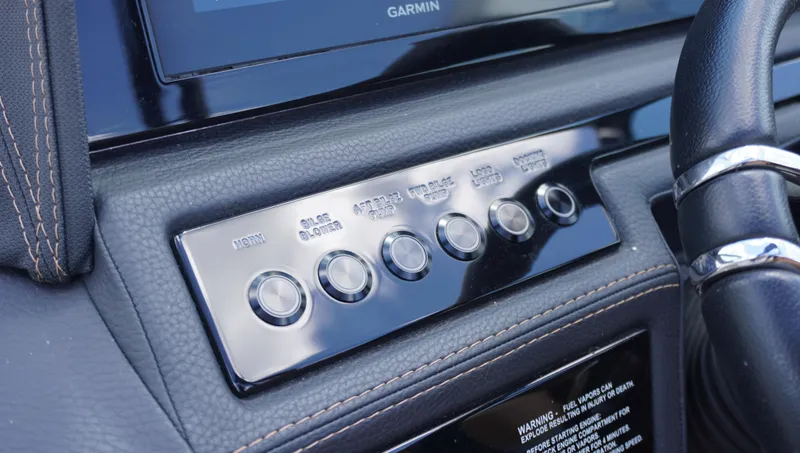Slide: The Image of Dashboard controls of a 2022 Cobalt R6 boat with leather trim and Garmin display. - 24