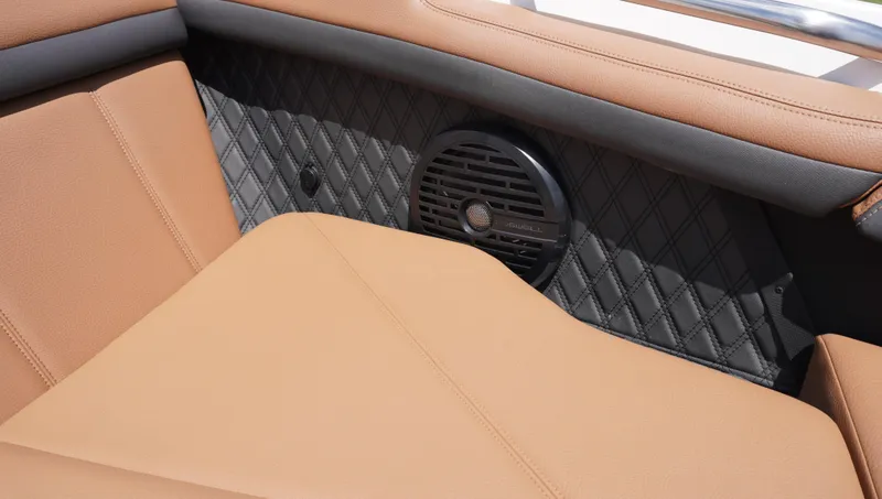 Slide: The Image of 2022 Cobalt R6 boat interior with tan leather seating and built-in speaker. - 33
