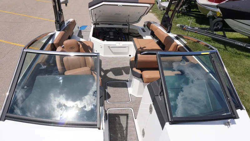 Slide: The Image of 2022 Cobalt R6 boat interior with tan seating and open engine compartment. - 34