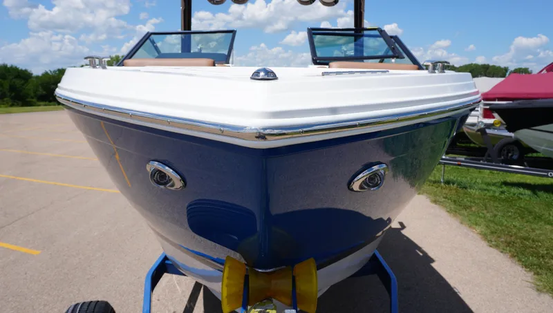 Slide: The Image of 2022 Cobalt R6 boat on trailer, blue and white design, parked outdoors under clear sky. - 4