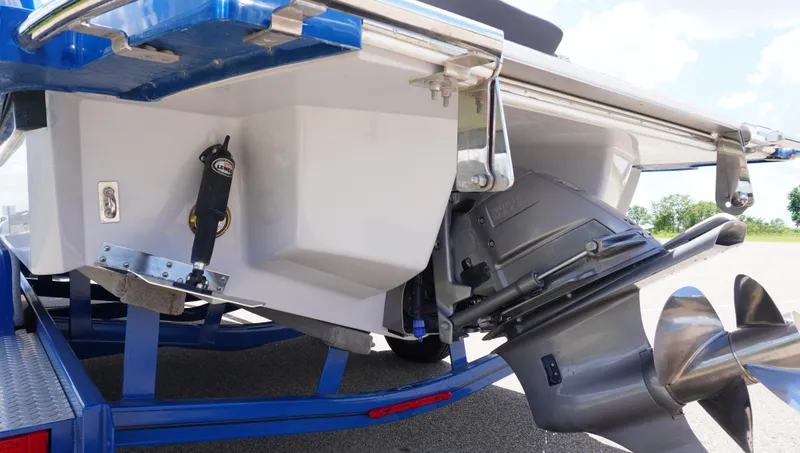Slide: The Image of 2022 Cobalt R6 boat stern with propeller and trim tabs on trailer. - 8