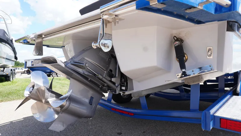 Slide: The Image of 2022 Cobalt R6 boat stern with propeller and trailer, parked outdoors. - 9