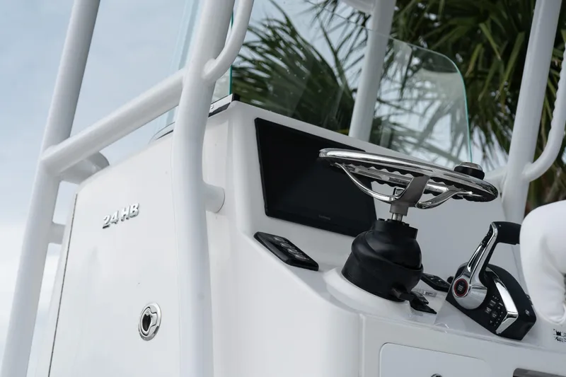 Slide: The Image of 2026 Caymas 24 HB boat console with steering wheel and controls. - 10
