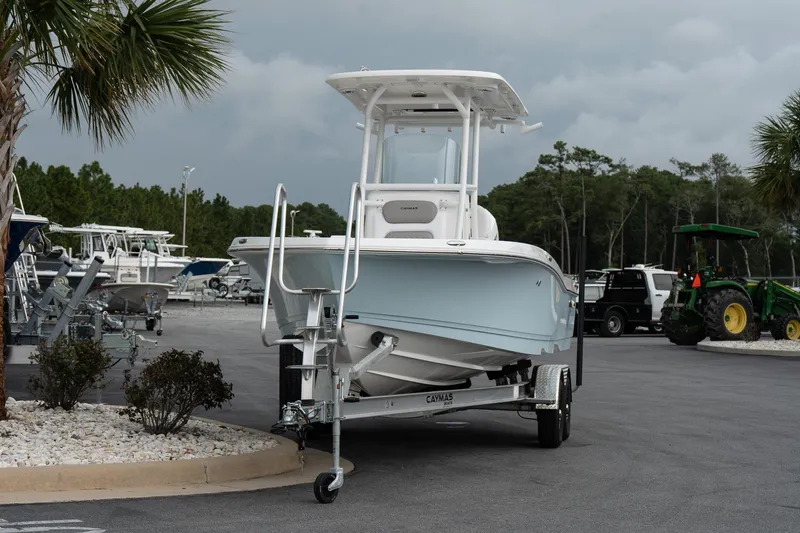 Slide: The Image of 2026 Caymas 24 HB boat on trailer in marina parking lot. - 3