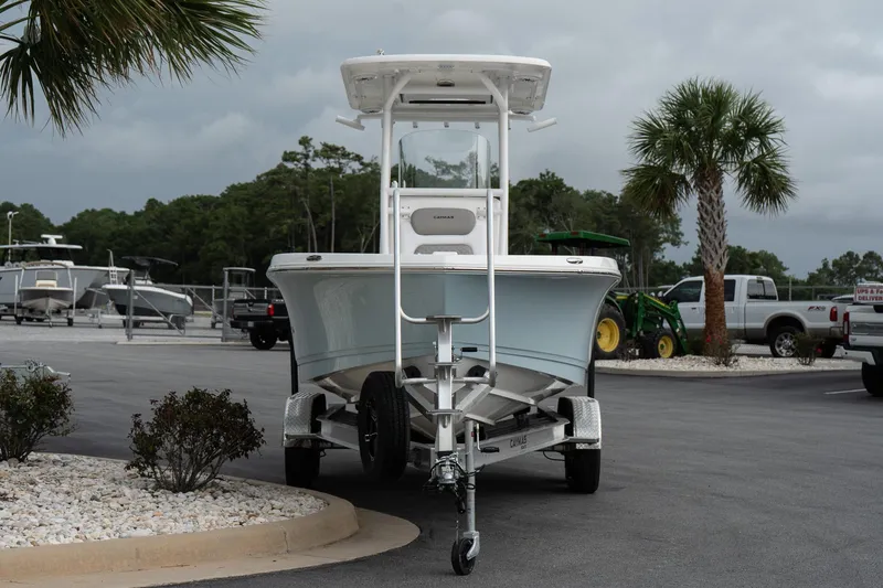 Slide: The Image of 2026 Caymas 24 HB boat on trailer in parking lot with palm trees. - 4