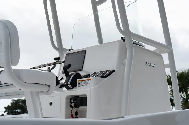 Slide: The Image of 2026 Caymas 24 HB boat console with steering wheel and controls. - 9