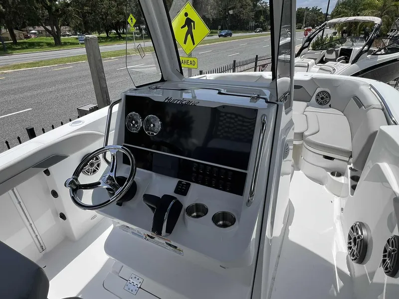 Slide: The Image of 2025 Hurricane Center Console 24 OB boat interior with steering wheel and seating area. - 2