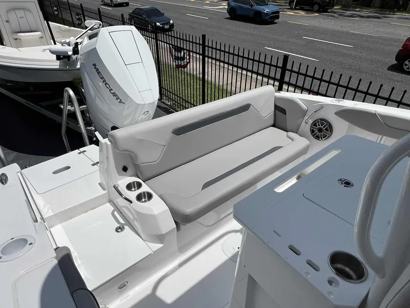 Slide: The Image of 2025 Hurricane Center Console 24 OB boat interior with seating, cup holders, and Mercury outboard motor. - 5