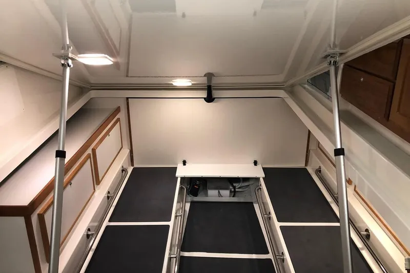 Slide: The Image of 2026 Back Cove 34O interior cabin with modern design and ample storage space. - 13