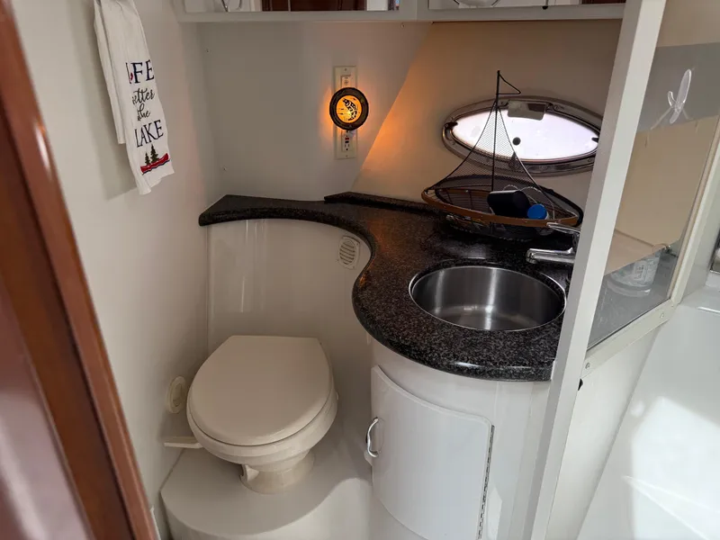 Slide: The Image of 2007 Carver 40 Motor Yacht bathroom with sink, toilet, and nautical decor. - 10