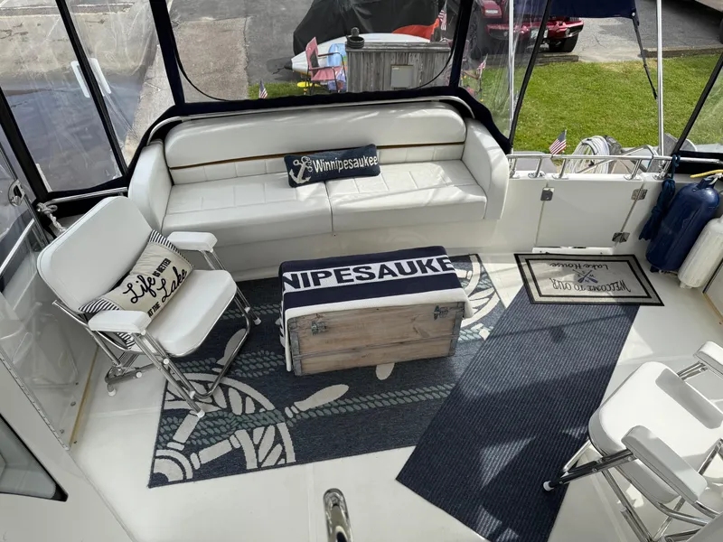 Slide: The Image of 2007 Carver 40 Motor Yacht interior with seating, nautical decor, and lake-themed pillows. - 12