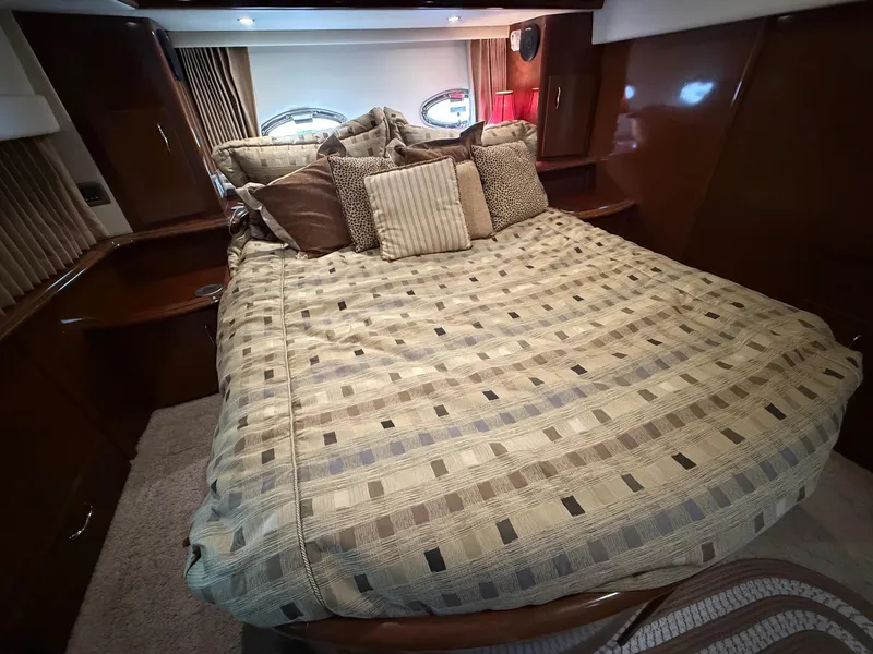 Slide: The Image of Luxurious bedroom interior of 2007 Carver 40 Motor Yacht with plush bedding and elegant decor. - 13