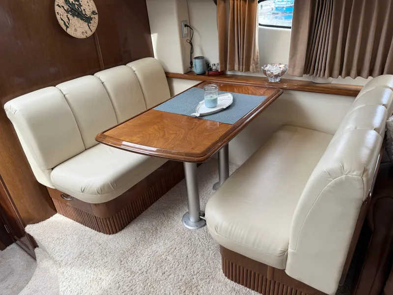 Slide: The Image of Luxurious interior of 2007 Carver 40 Motor Yacht with elegant dining area and plush seating. - 16