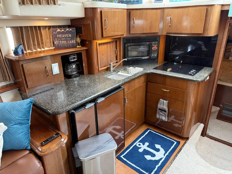 Slide: The Image of Luxurious kitchen interior of 2007 Carver 40 Motor Yacht with modern appliances and nautical decor. - 18