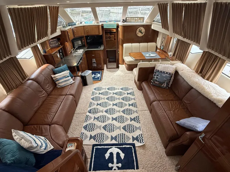 Slide: The Image of Luxurious interior of a 2007 Carver 40 Motor Yacht with leather sofas and nautical decor. - 21