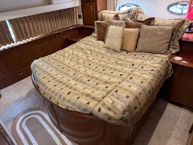 Slide: The Image of Luxurious bedroom interior of 2007 Carver 40 Motor Yacht with plush bedding and pillows. - 27
