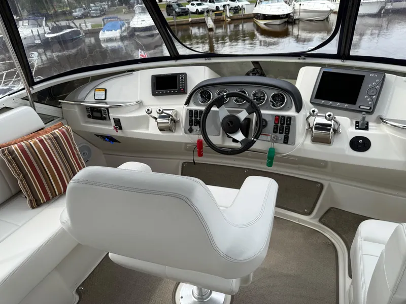 Slide: The Image of 2007 Carver 40 Motor Yacht helm with modern controls and comfortable seating. - 4