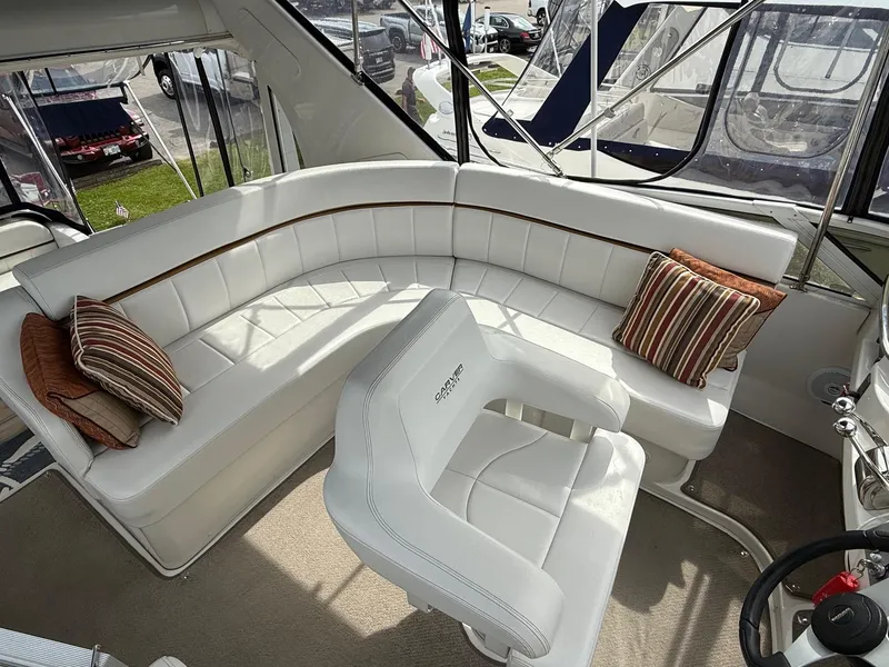 Slide: The Image of Interior of 2007 Carver 40 Motor Yacht with white seating and striped cushions. - 7