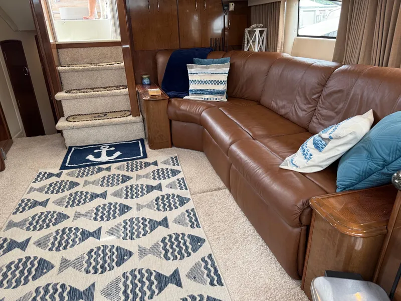 Slide: The Image of Interior of 2007 Carver 40 Motor Yacht with brown leather sofa and nautical-themed decor. - 8