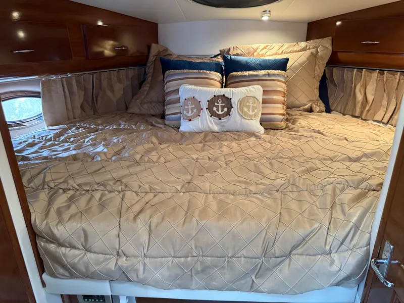 Slide: The Image of Luxurious bedroom in 2007 Carver 40 Motor Yacht with nautical-themed pillows. - 9