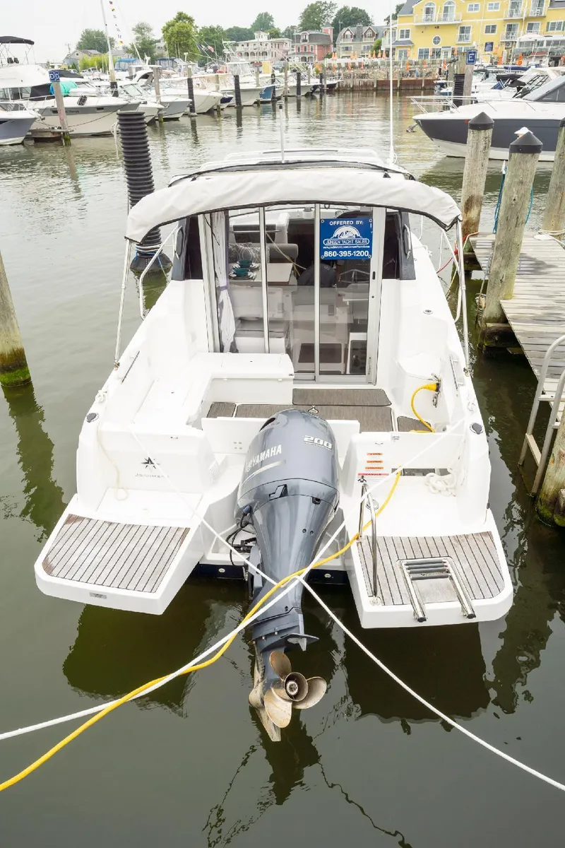 Slide: The Image of 2021 Jeanneau NC Weekender 795 Series 2 docked, rear view with Yamaha outboard motor. - 1