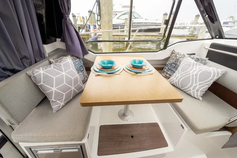 Slide: The Image of Interior of 2021 Jeanneau NC Weekender 795 Series 2 with cozy dining area and cushions. - 19