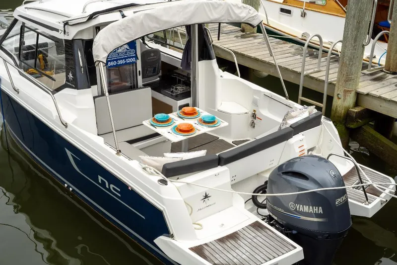 Slide: The Image of 2021 Jeanneau NC Weekender 795 Series 2 boat docked with Yamaha engine. - 2